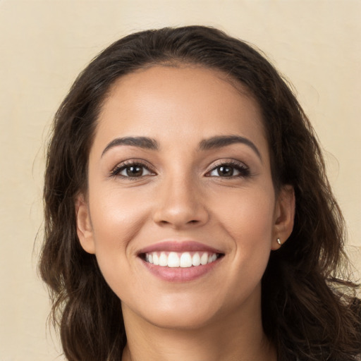 Joyful white young-adult female with long  brown hair and brown eyes