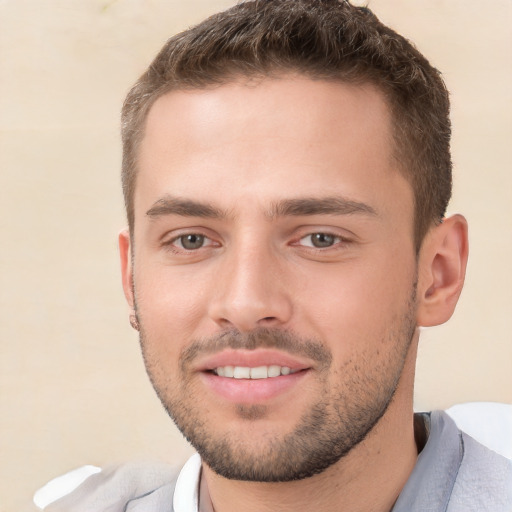 Joyful white young-adult male with short  brown hair and brown eyes