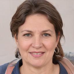 Joyful white adult female with medium  brown hair and brown eyes