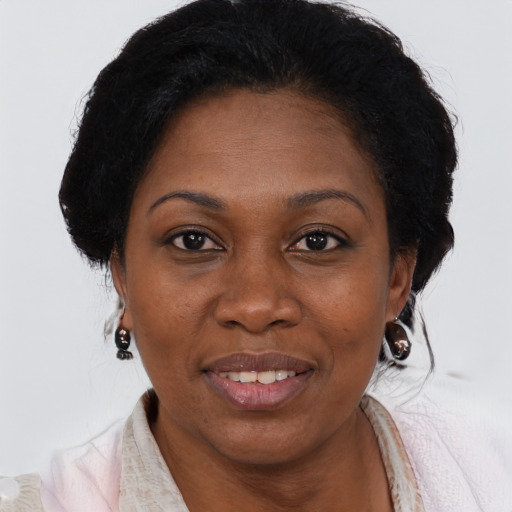 Joyful black adult female with short  brown hair and brown eyes