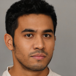 Neutral latino young-adult male with short  black hair and brown eyes