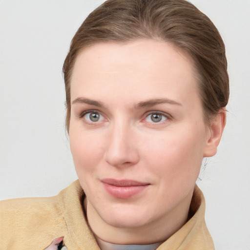 Joyful white young-adult female with short  brown hair and blue eyes