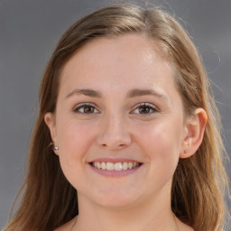 Joyful white young-adult female with long  brown hair and blue eyes