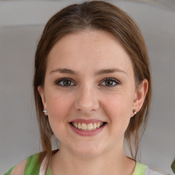 Joyful white young-adult female with medium  brown hair and blue eyes