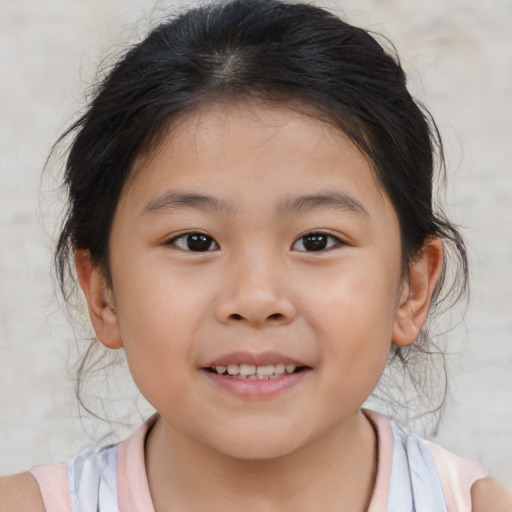 Joyful asian child female with medium  brown hair and brown eyes