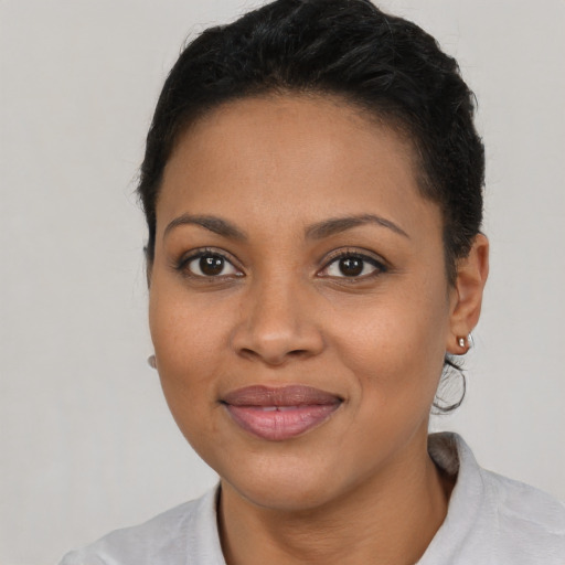 Joyful latino young-adult female with short  brown hair and brown eyes