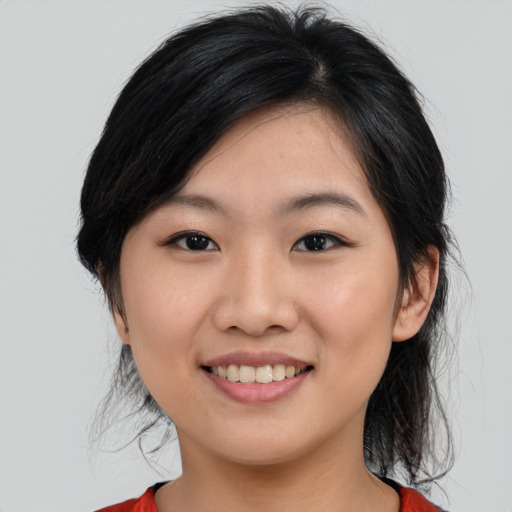 Joyful asian young-adult female with medium  black hair and brown eyes