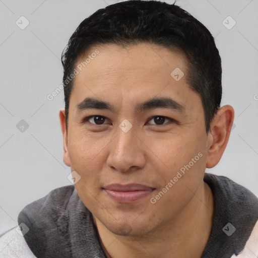 Joyful latino young-adult male with short  black hair and brown eyes