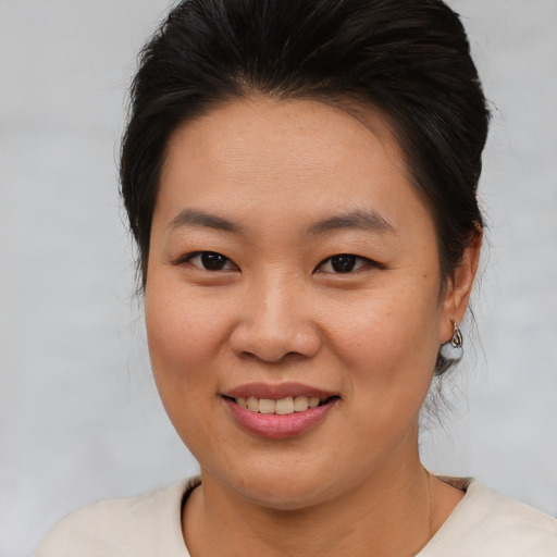 Joyful asian young-adult female with medium  brown hair and brown eyes