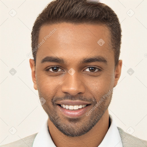 Joyful black young-adult male with short  brown hair and brown eyes