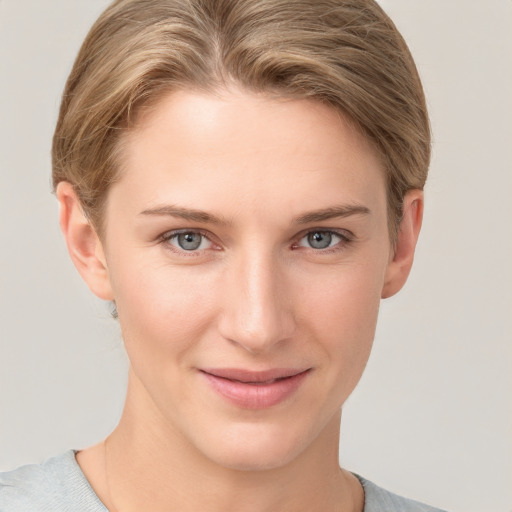 Joyful white young-adult female with short  brown hair and grey eyes