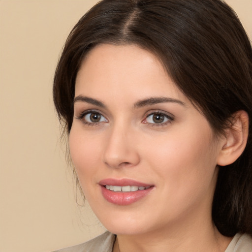 Joyful white young-adult female with medium  brown hair and brown eyes