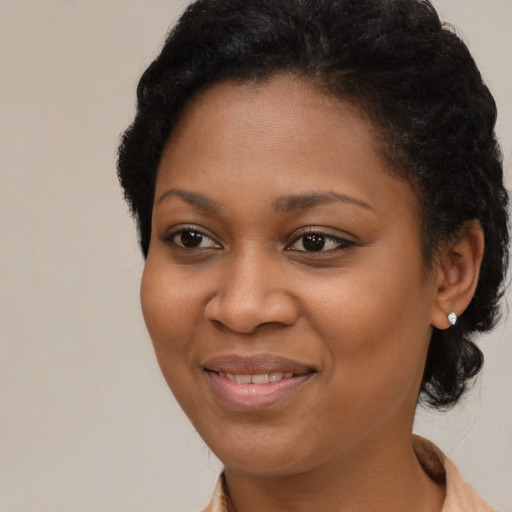 Joyful black young-adult female with medium  brown hair and brown eyes