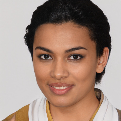 Joyful latino young-adult female with short  black hair and brown eyes
