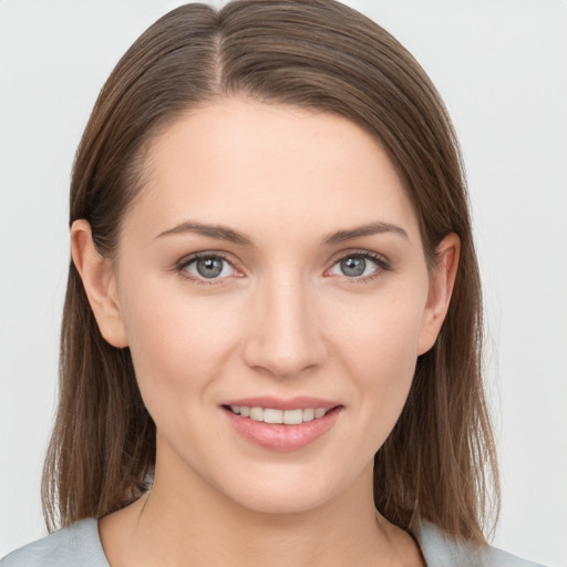 Joyful white young-adult female with medium  brown hair and grey eyes