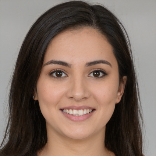 Joyful white young-adult female with long  brown hair and brown eyes