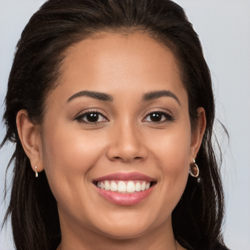 Joyful white young-adult female with long  brown hair and brown eyes