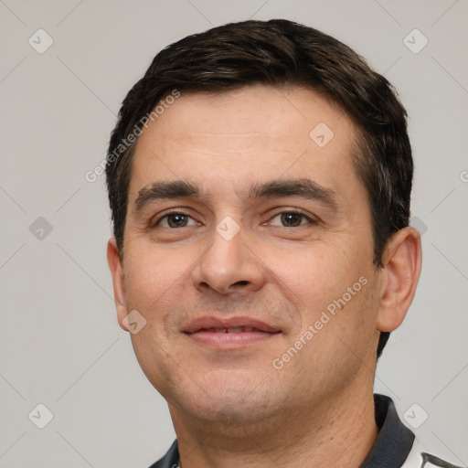 Joyful white young-adult male with short  black hair and brown eyes