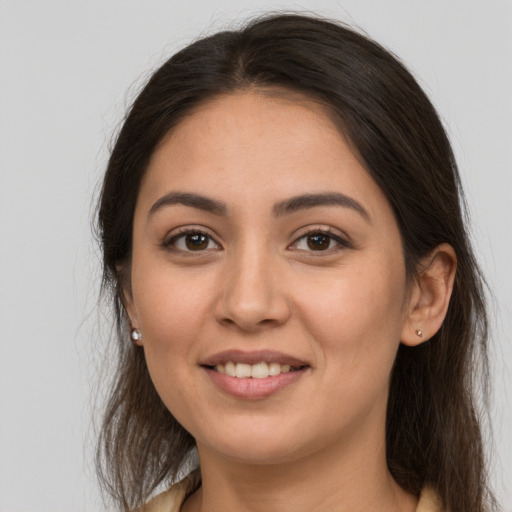 Joyful white young-adult female with long  brown hair and brown eyes