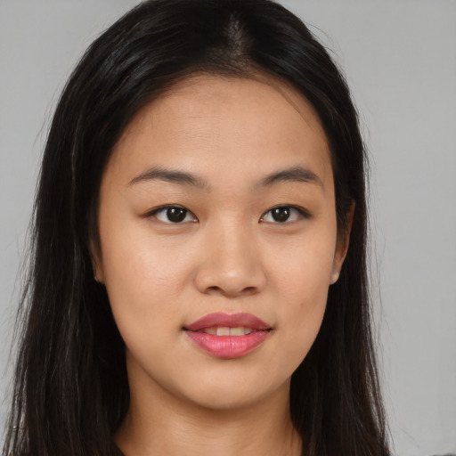 Joyful asian young-adult female with long  brown hair and brown eyes