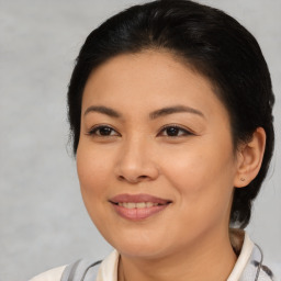 Joyful asian young-adult female with medium  brown hair and brown eyes