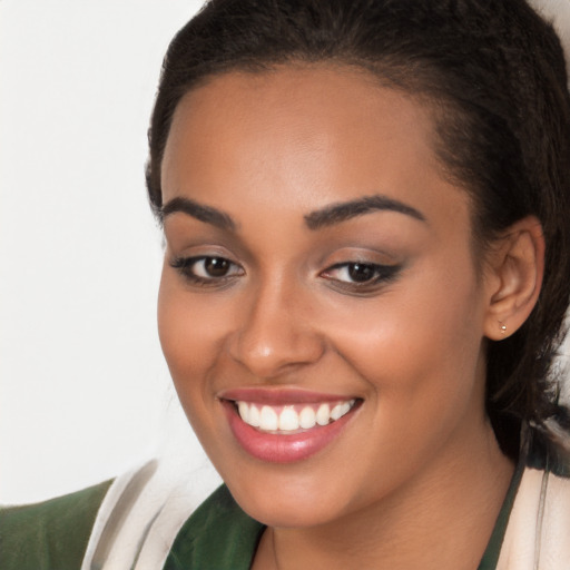 Joyful latino young-adult female with long  brown hair and brown eyes