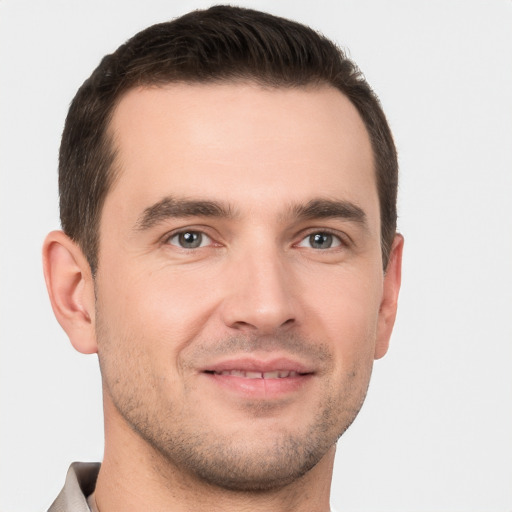 Joyful white young-adult male with short  brown hair and brown eyes