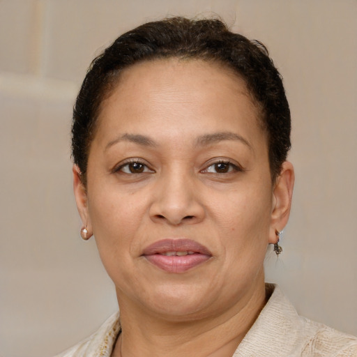 Joyful latino adult female with short  brown hair and brown eyes