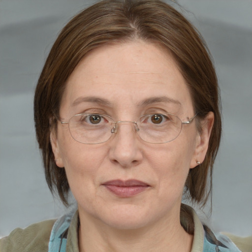 Joyful white adult female with medium  brown hair and blue eyes