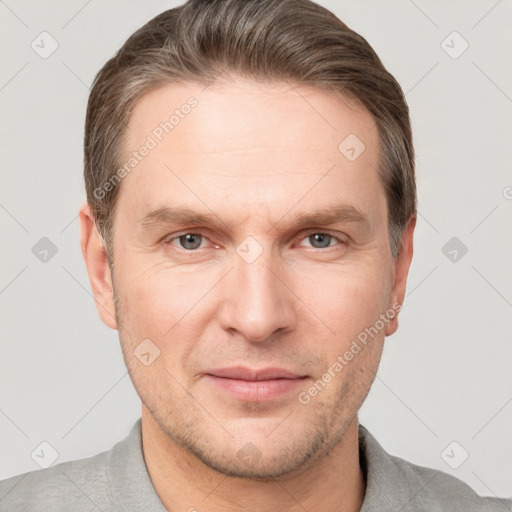 Joyful white adult male with short  brown hair and grey eyes