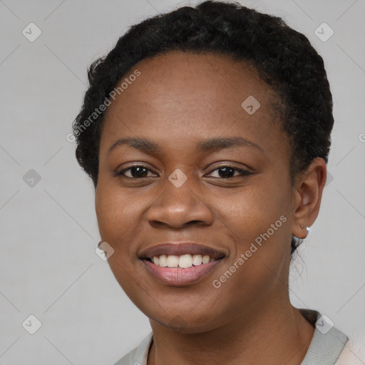 Joyful black young-adult female with short  black hair and brown eyes