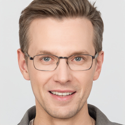 Joyful white adult male with short  brown hair and grey eyes