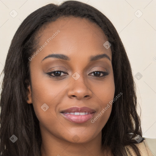 Joyful black young-adult female with long  brown hair and brown eyes