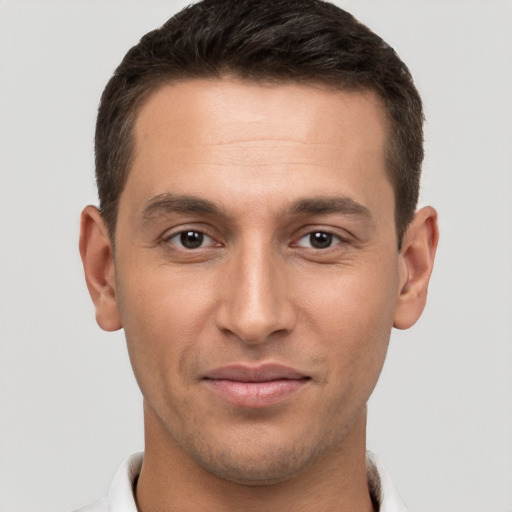 Joyful white young-adult male with short  brown hair and brown eyes