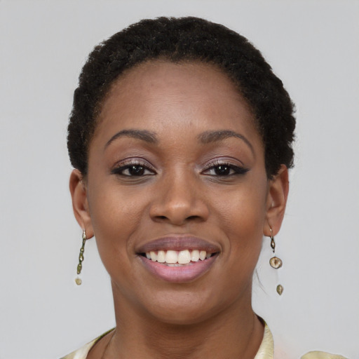 Joyful black young-adult female with short  brown hair and brown eyes