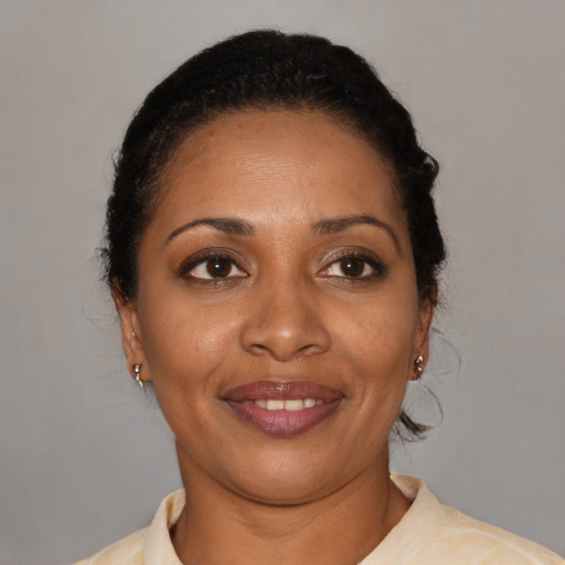 Joyful black young-adult female with short  brown hair and brown eyes