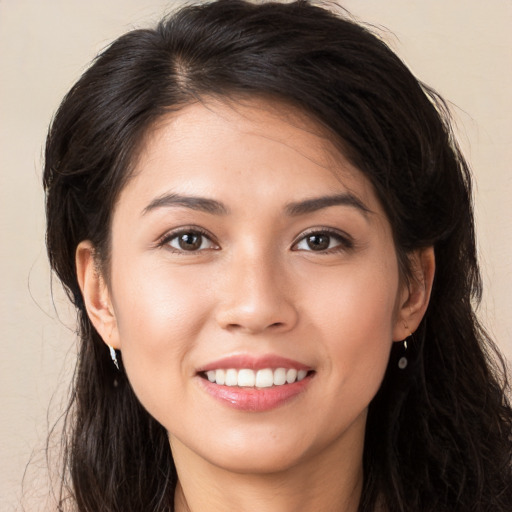 Joyful white young-adult female with long  brown hair and brown eyes