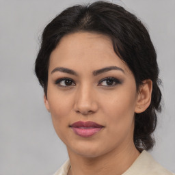 Joyful latino young-adult female with medium  brown hair and brown eyes