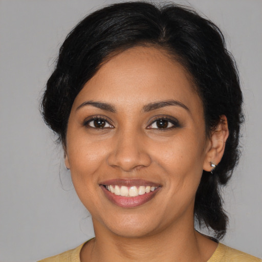 Joyful latino young-adult female with medium  black hair and brown eyes