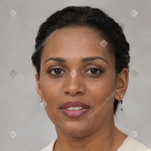 Joyful black adult female with short  brown hair and brown eyes