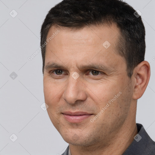 Joyful white adult male with short  brown hair and brown eyes