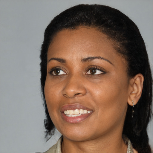 Joyful black young-adult female with medium  black hair and brown eyes