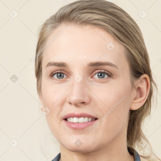 Joyful white young-adult female with medium  brown hair and blue eyes