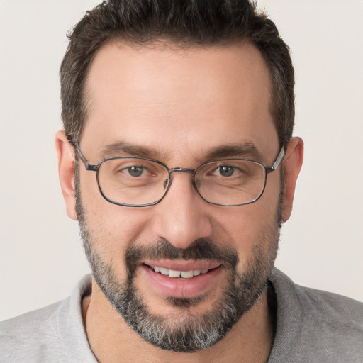 Joyful white adult male with short  brown hair and brown eyes