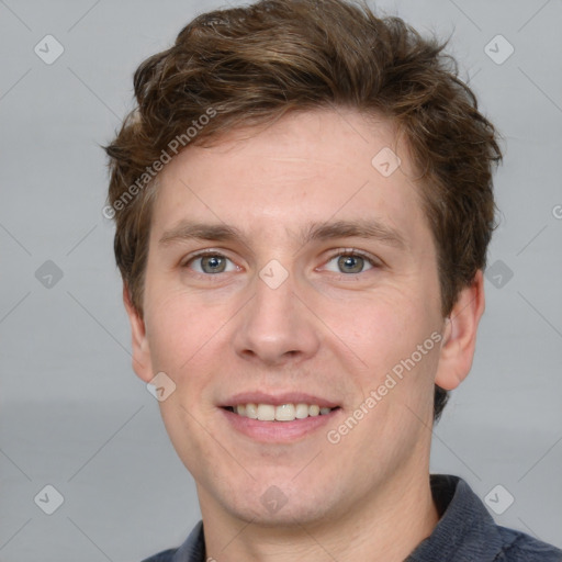 Joyful white adult male with short  brown hair and grey eyes