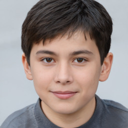 Joyful white child male with short  brown hair and brown eyes