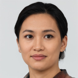 Joyful asian young-adult female with short  brown hair and brown eyes