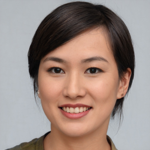 Joyful asian young-adult female with medium  brown hair and brown eyes