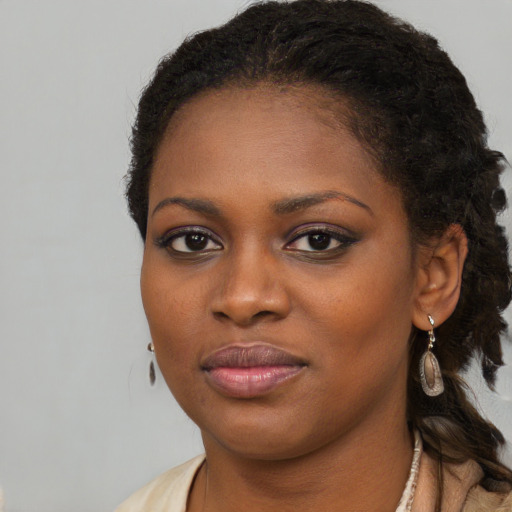Joyful black young-adult female with medium  brown hair and brown eyes
