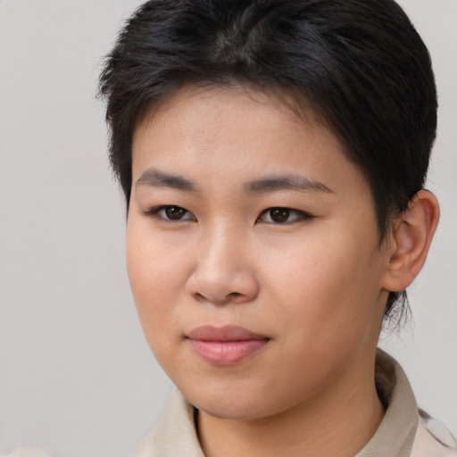 Joyful asian young-adult female with short  brown hair and brown eyes